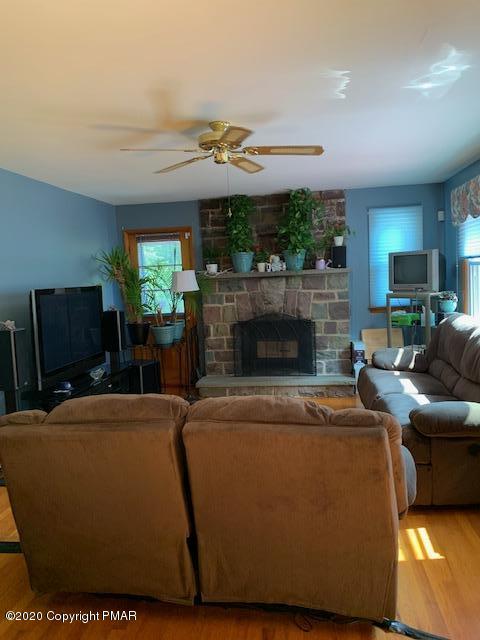 204 Winona Road Mount Pocono, PA 18344 - Photo 8 of 41 a living room with furniture a fireplace and a flat screen tv