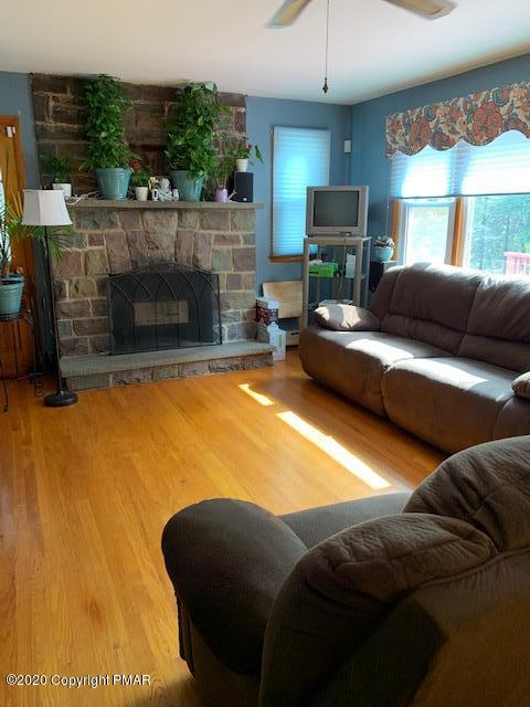204 Winona Road Mount Pocono, PA 18344 - Photo 9 of 41 a living room with furniture and a fireplace