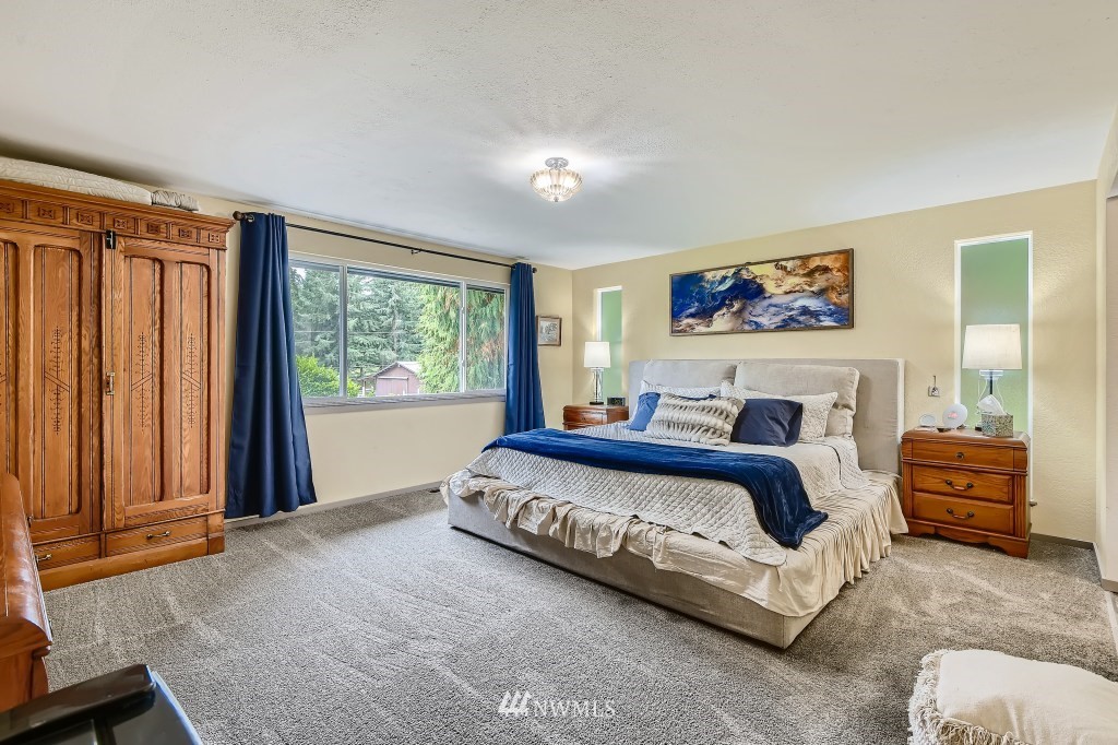 22420 61st Avenue Southeast Bothell, WA 98021 - Photo 12 of 39 a view of a bedroom with furniture and windows