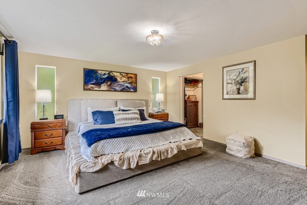 22420 61st Avenue Southeast Bothell, WA 98021 - Photo 13 of 39 a bedroom with a bed and a painting on the wall