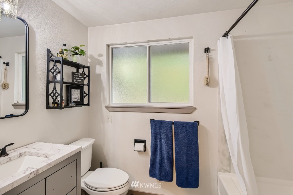 22420 61st Avenue Southeast Bothell, WA 98021 - Photo 16 of 39 a bathroom with a toilet a sink and mirror