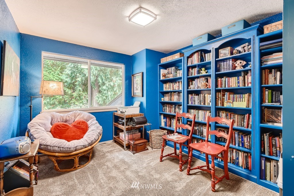 22420 61st Avenue Southeast Bothell, WA 98021 - Photo 20 of 39 a living room with furniture and a book shelf