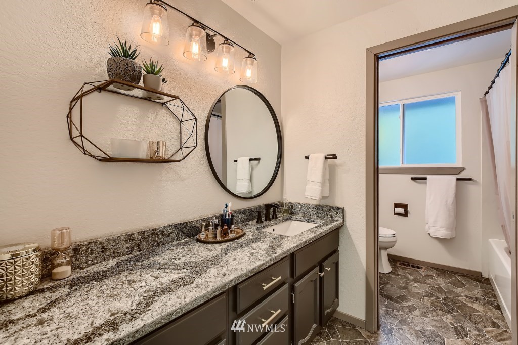 22420 61st Avenue Southeast Bothell, WA 98021 - Photo 22 of 39 a bathroom with a granite countertop sink and a mirror