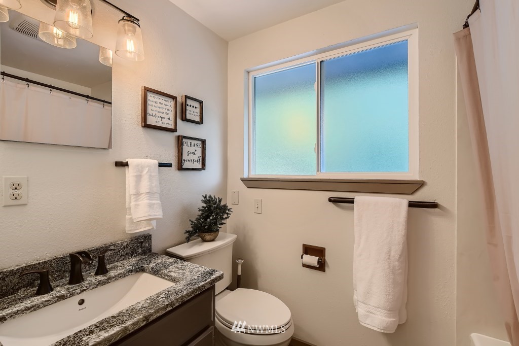 22420 61st Avenue Southeast Bothell, WA 98021 - Photo 23 of 39 a bathroom with a granite countertop sink toilet and mirror