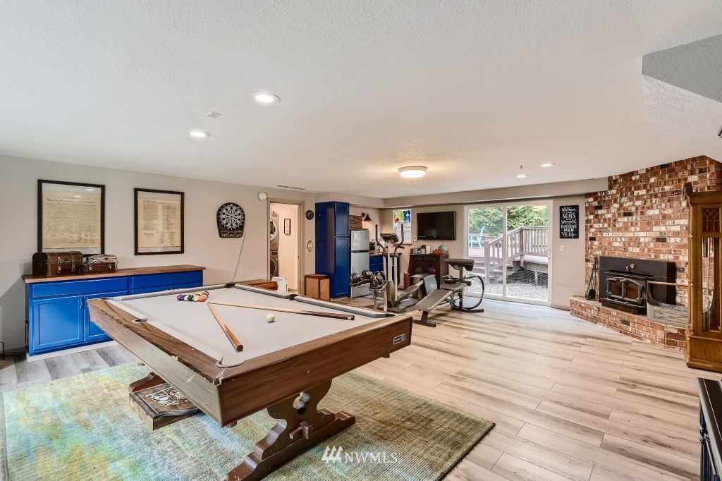 22420 61st Avenue Southeast Bothell, WA 98021 - Photo 24 of 39 a living room with furniture pool table and a fireplace