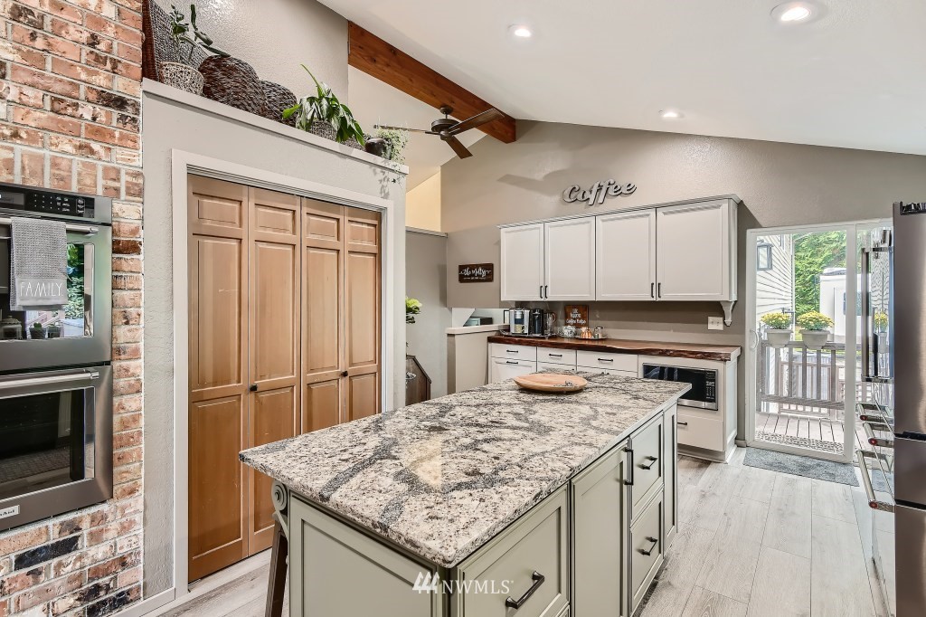 22420 61st Avenue Southeast Bothell, WA 98021 - Photo 10 of 39 a kitchen with a stove a sink and a refrigerator