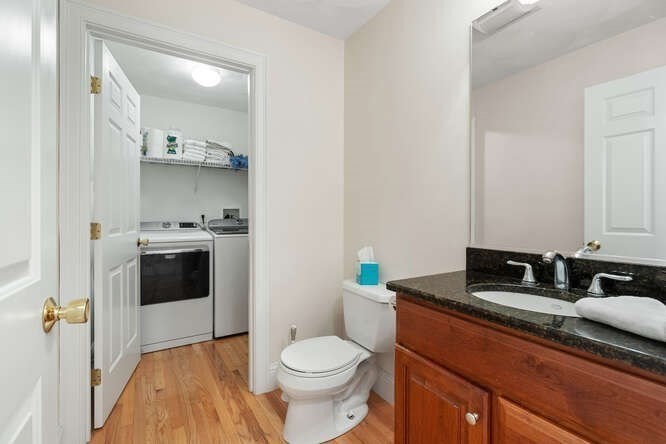 1 Ash Lane Georgetown, MA 01833 - Photo 22 of 42 a bathroom with a granite countertop toilet sink and mirror