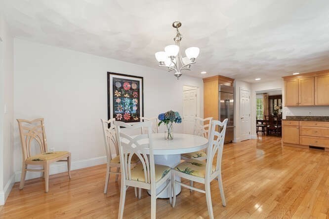 1 Ash Lane Georgetown, MA 01833 - Photo 10 of 42 a view of a dining room with furniture and wooden floor