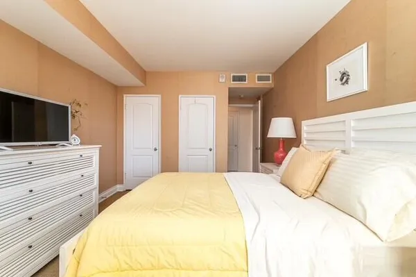 a bedroom with a bed and flat screen tv