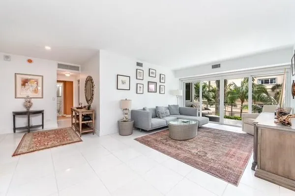 a living room with furniture and a floor to ceiling window