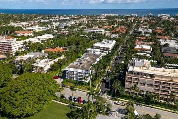 an aerial view of residential building and car parked on street side