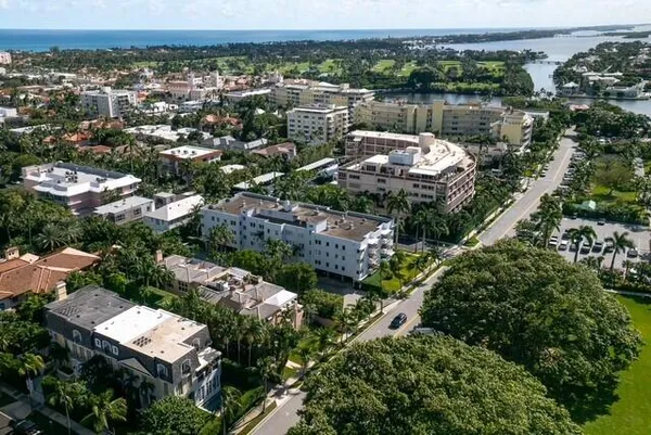 an aerial view of a residential houses with yard