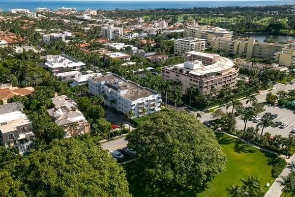 aerial view of a city with lots of residential buildings ocean and mountain view in back