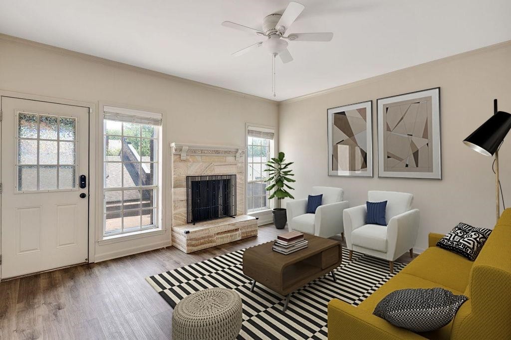 a living room with furniture a window and a fireplace