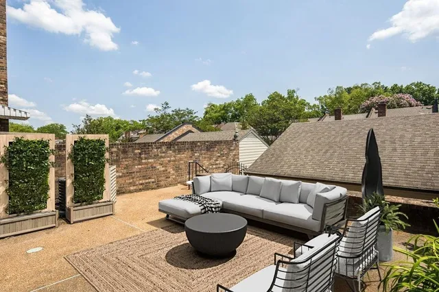 a view of a patio with couches and potted plants
