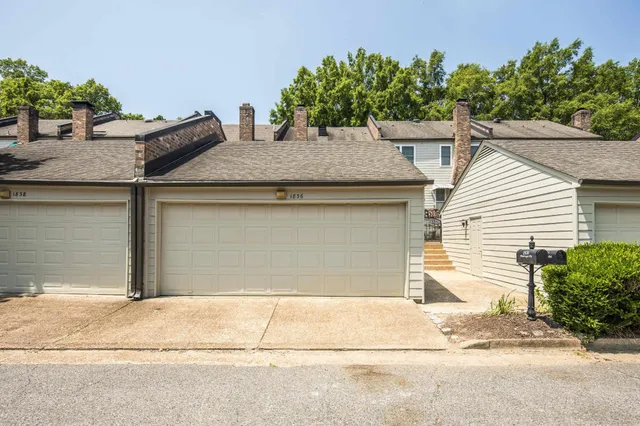 a house that has a tree in front of it