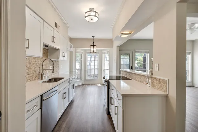 a spacious bathroom with a sink double vanity and a tub