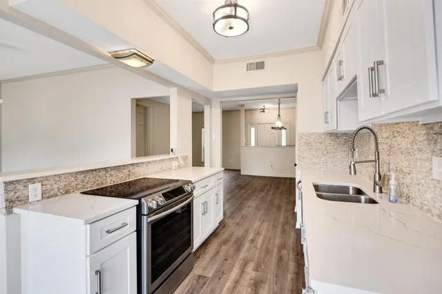 a kitchen with stainless steel appliances granite countertop a stove and a sink
