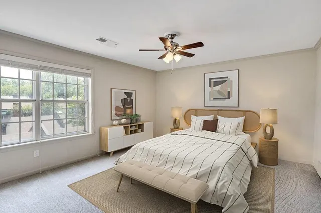 a bedroom with a large bed and a window