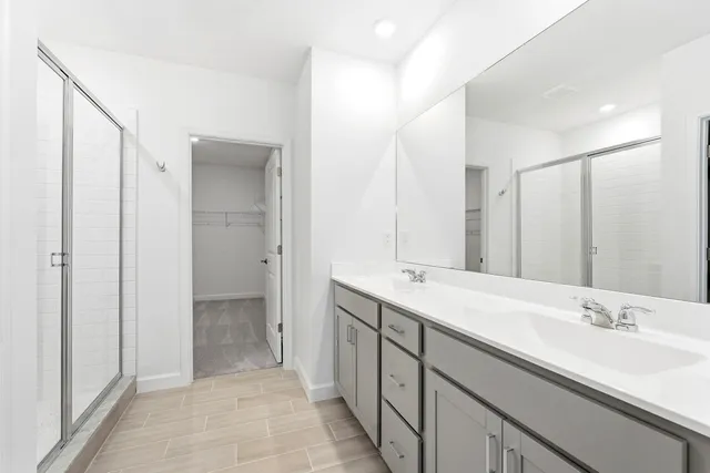 a bathroom with a double vanity sink and a mirror