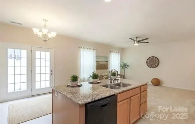 a view of a kitchen with kitchen island wooden floor center island and stainless steel appliances