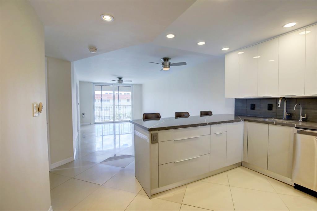 a kitchen with stainless steel appliances granite countertop a sink and cabinets