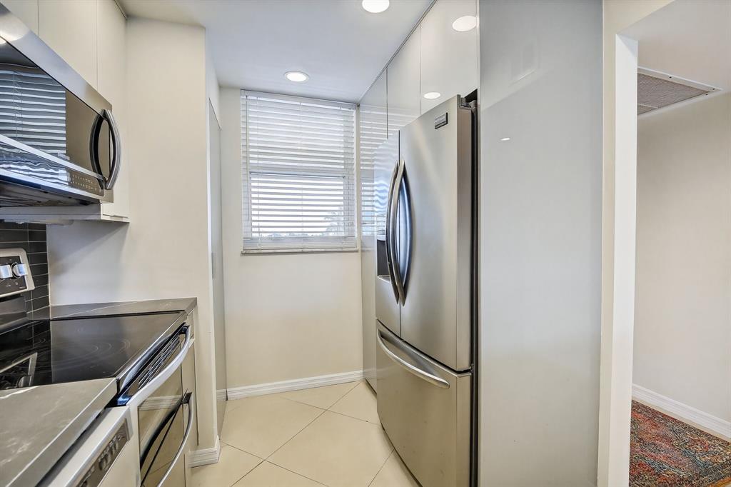 5321 Northeast 24th Terrace, Unit 504A Fort Lauderdale, FL 33308 - Photo 21 of 35 a kitchen with stainless steel appliances granite countertop a refrigerator and a sink