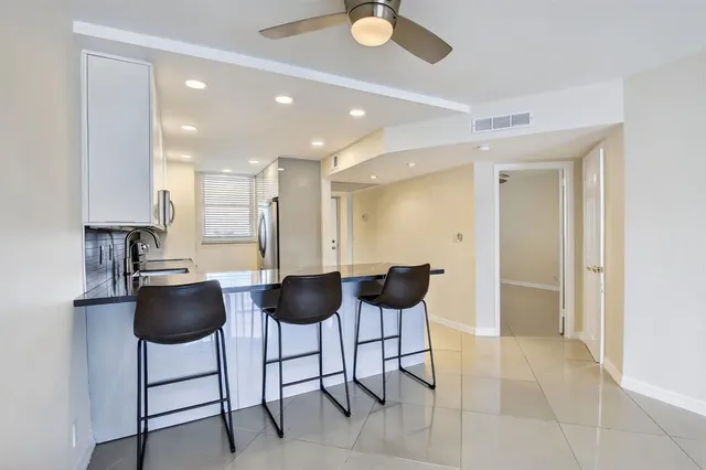 a kitchen with stainless steel appliances granite countertop a stove and a microwave
