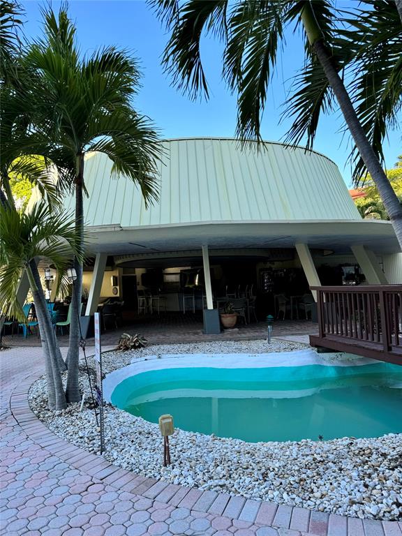 5321 Northeast 24th Terrace, Unit 504A Fort Lauderdale, FL 33308 - Photo 35 of 35 a view of house with swimming pool outdoor seating area and barbeque oven