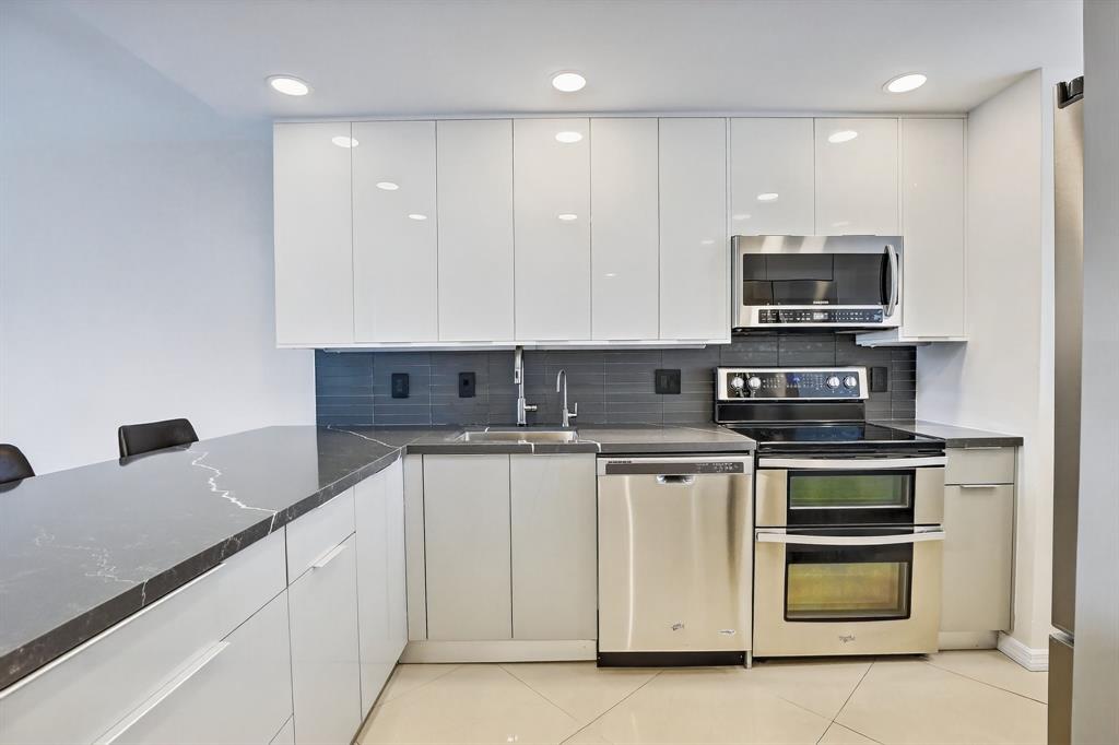 5321 Northeast 24th Terrace, Unit 504A Fort Lauderdale, FL 33308 - Photo 4 of 35 a kitchen with stainless steel appliances granite countertop a stove and a microwave