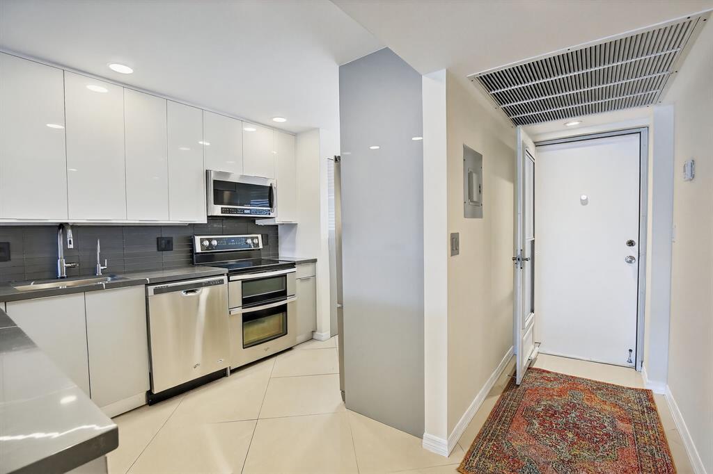 5321 Northeast 24th Terrace, Unit 504A Fort Lauderdale, FL 33308 - Photo 5 of 35 a kitchen with stainless steel appliances granite countertop a refrigerator and a stove top oven