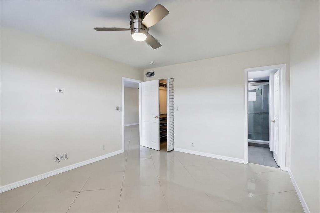 5321 Northeast 24th Terrace, Unit 504A Fort Lauderdale, FL 33308 - Photo 9 of 35 an empty room with closet and a ceiling fan
