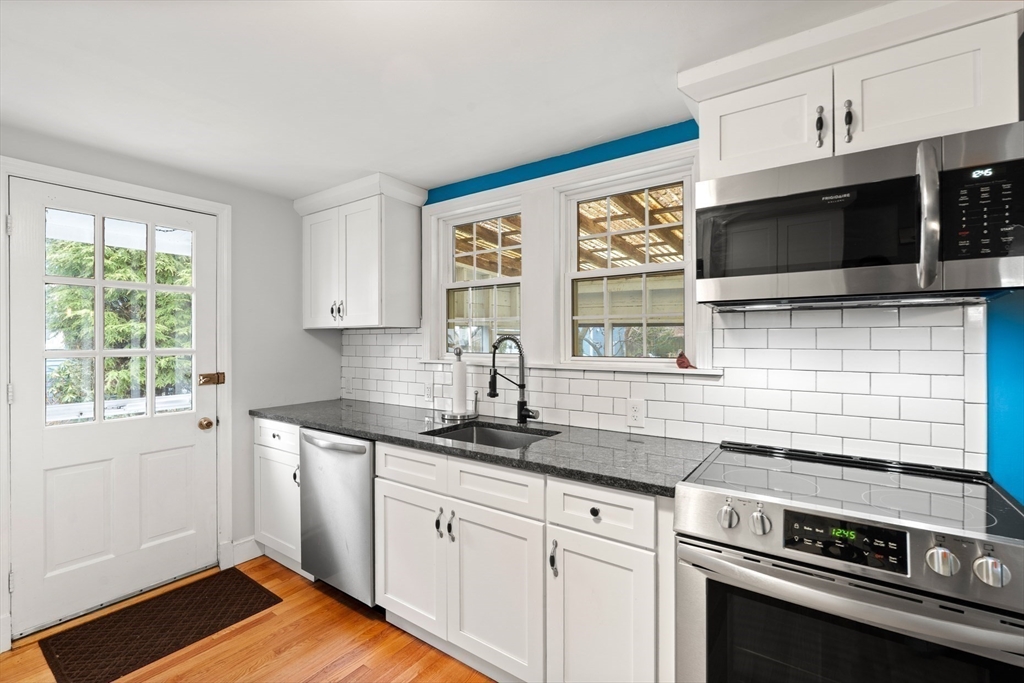 72 Village Street Marblehead, MA 01945 - Photo 5 of 22 a kitchen with stainless steel appliances a stove sink and microwave