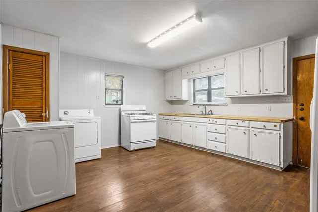 a kitchen with white cabinets sink and white appliances