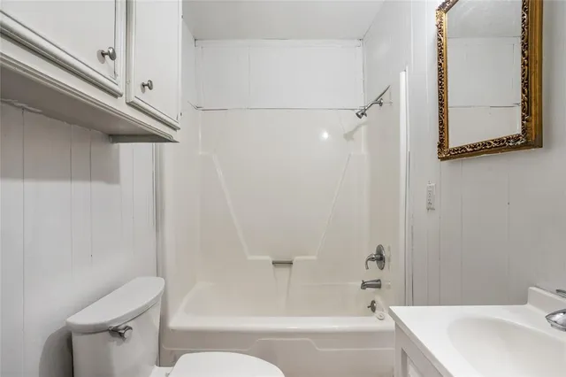 a bathroom with a toilet and a bathtub