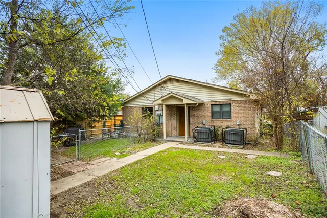 a view of a house with a yard and sitting area