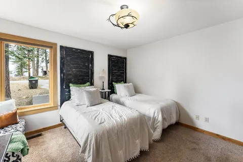 a bedroom with double bed and a window