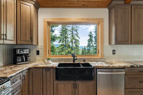 a kitchen with granite countertop a sink and a window