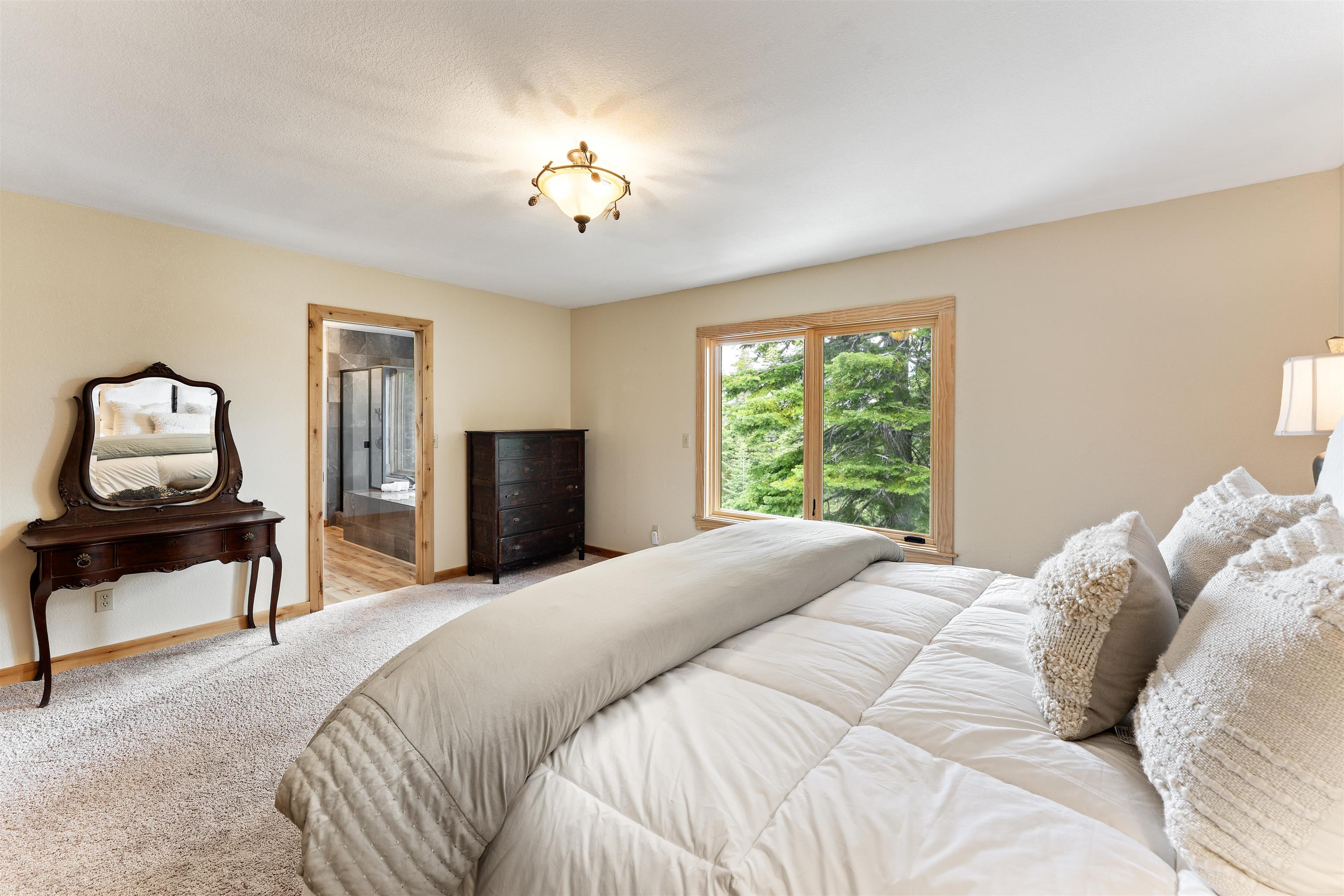 12185 Ski Slope Way Truckee, CA 96161 - Photo 9 of 27 a bedroom with a bed and a chandelier