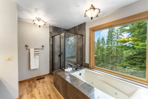 a spacious bathroom with a large tub and shower