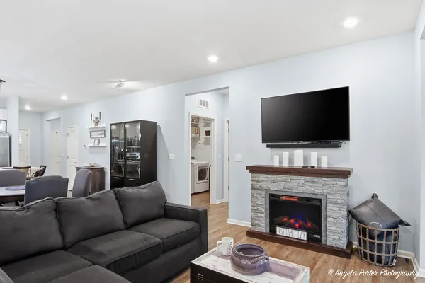 a living room with furniture a fireplace and a flat screen tv