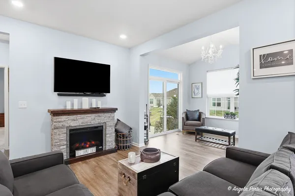 a living room with furniture a fireplace and a flat screen tv