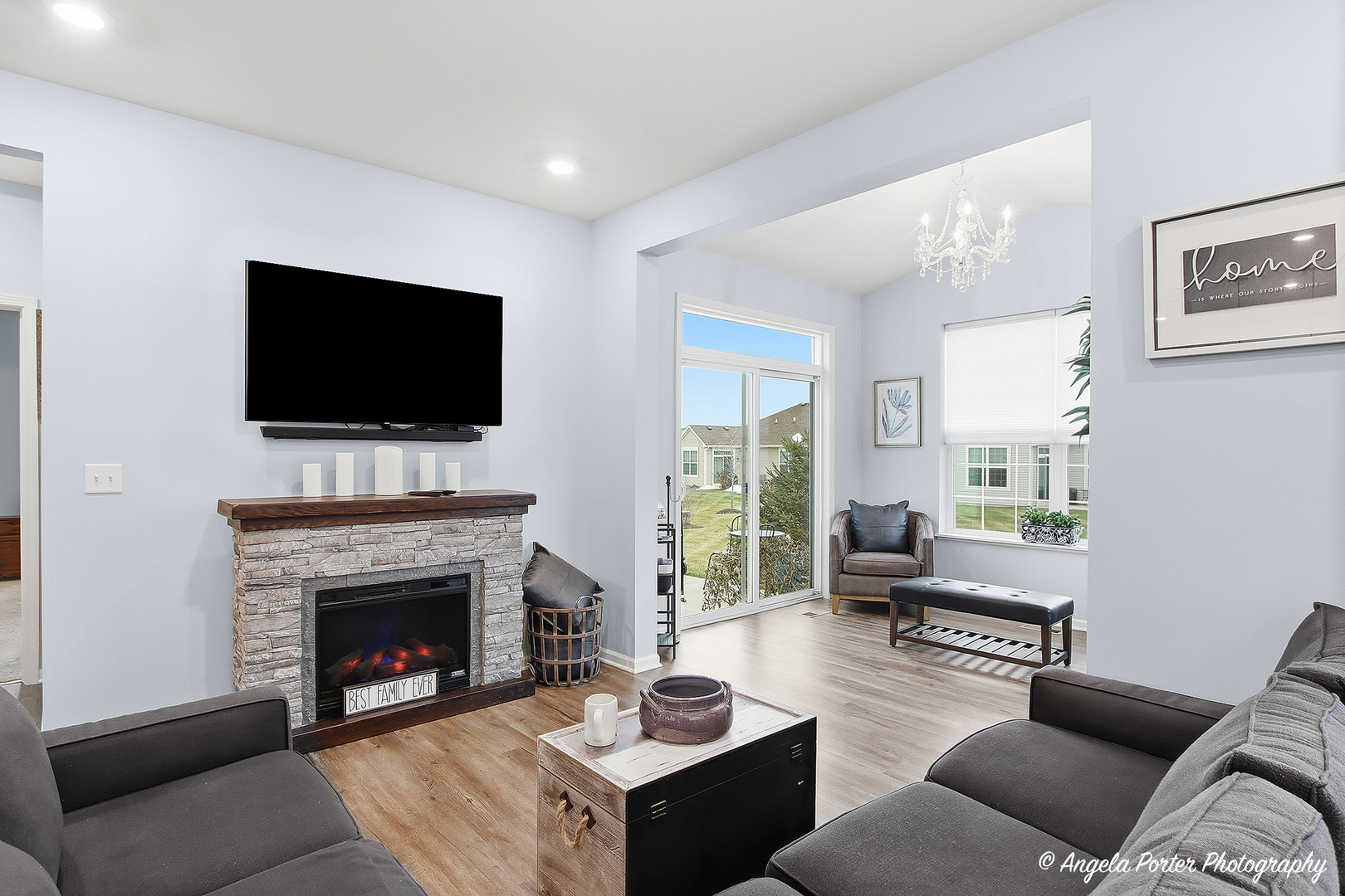 9186 Ritz Court Huntley, IL 60142 - Photo 23 of 36 a living room with furniture a fireplace and a flat screen tv
