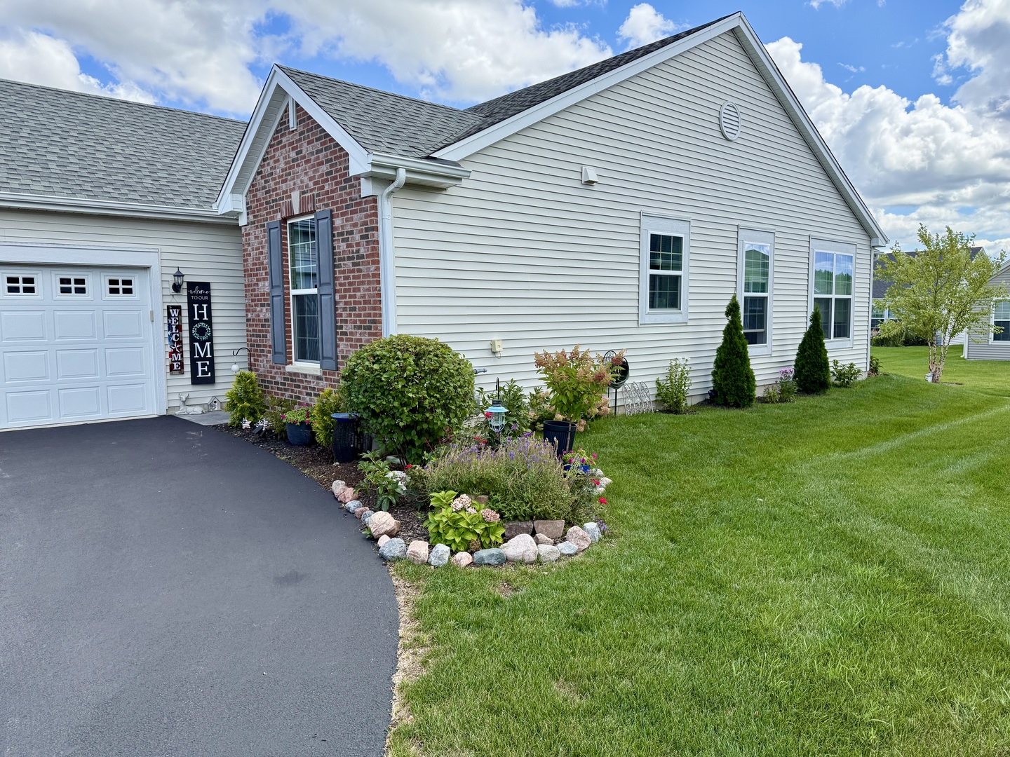 9186 Ritz Court Huntley, IL 60142 - Photo 32 of 36 a front view of house with a garden and patio