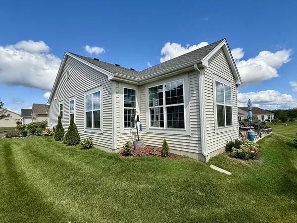 a front view of house with yard and outdoor seating