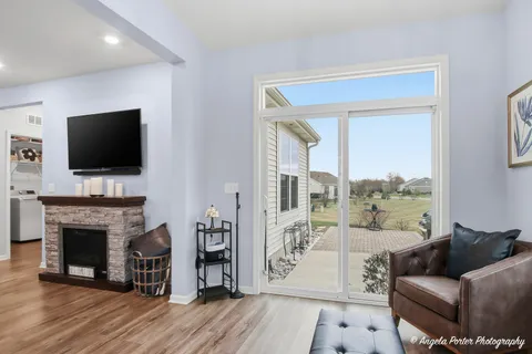 a living room with furniture fireplace and flat screen tv