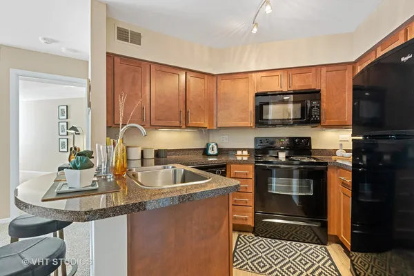 a kitchen with a sink stove and microwave