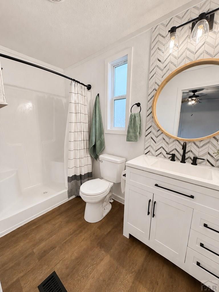 6652 County Rd HH.5 Lamar, CO 81052 - Photo 14 of 22 a bathroom with a sink mirror vanity and toilet