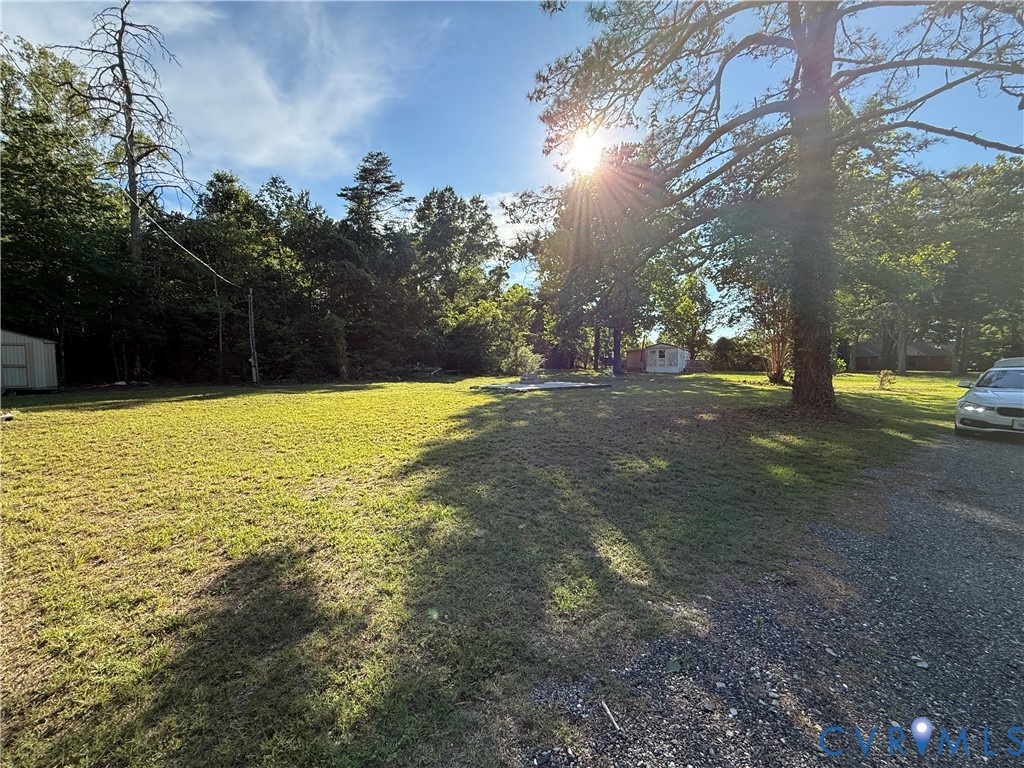 88 Seahawk Road Urbanna, VA 23175 - Photo 11 of 16 Expansive lot featuring mature trees, a gravel dri