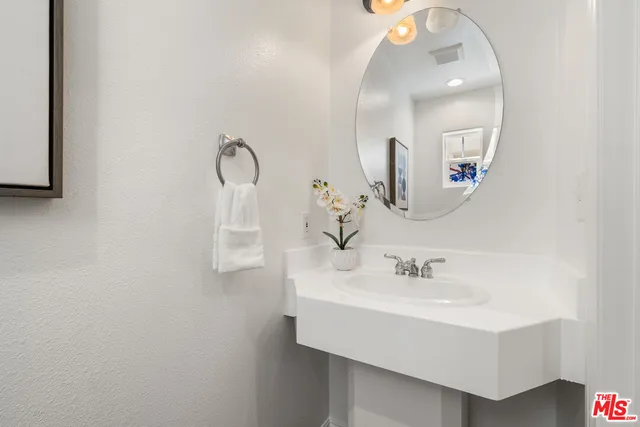 a bathroom with a sink mirror and vanity
